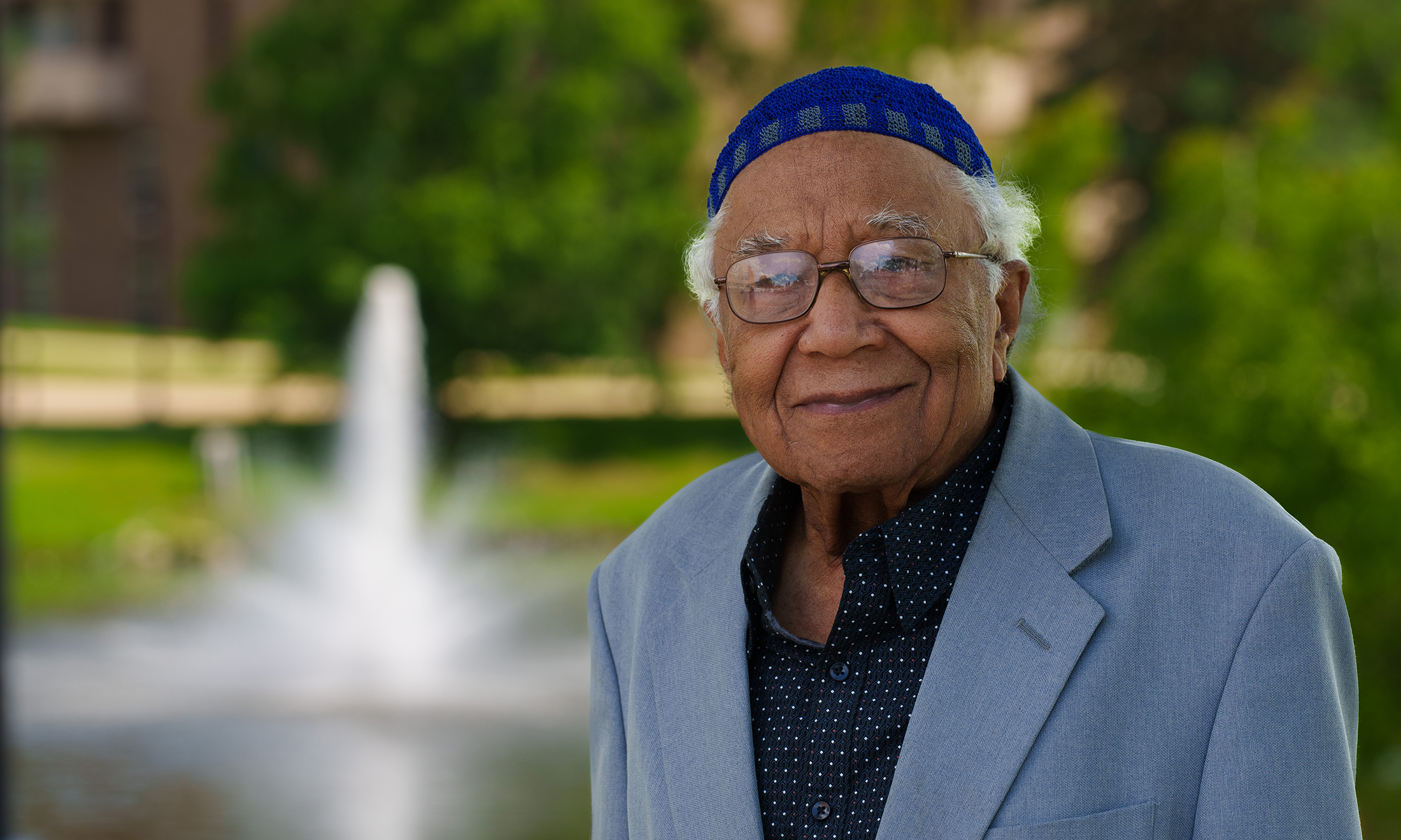 Dr Karl Gregory smiling with a fountain in the background