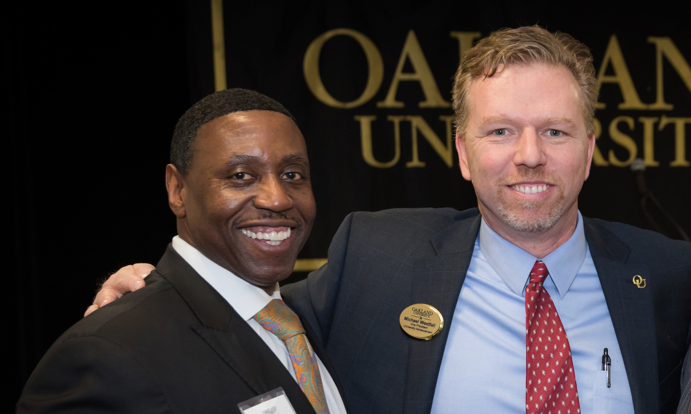 Two men standing inside