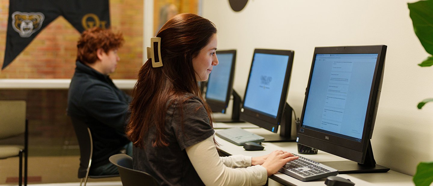 Students seated at a row of computers