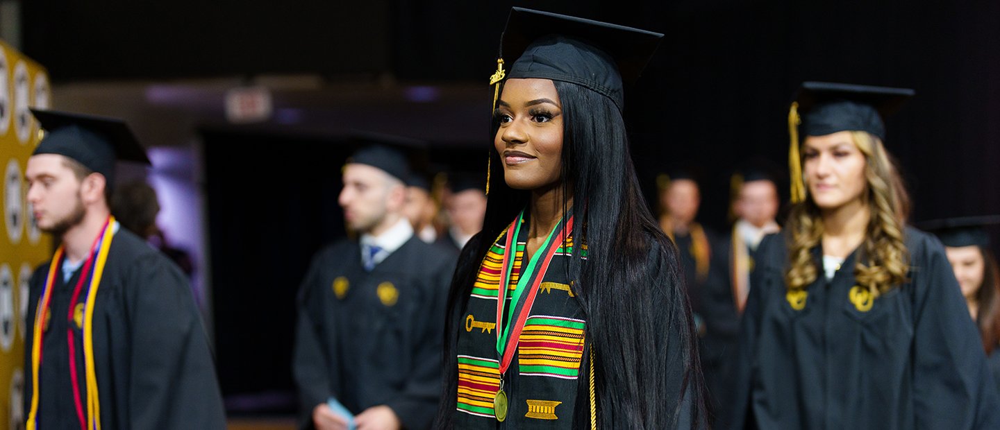 Students in caps and gowns at commencement.