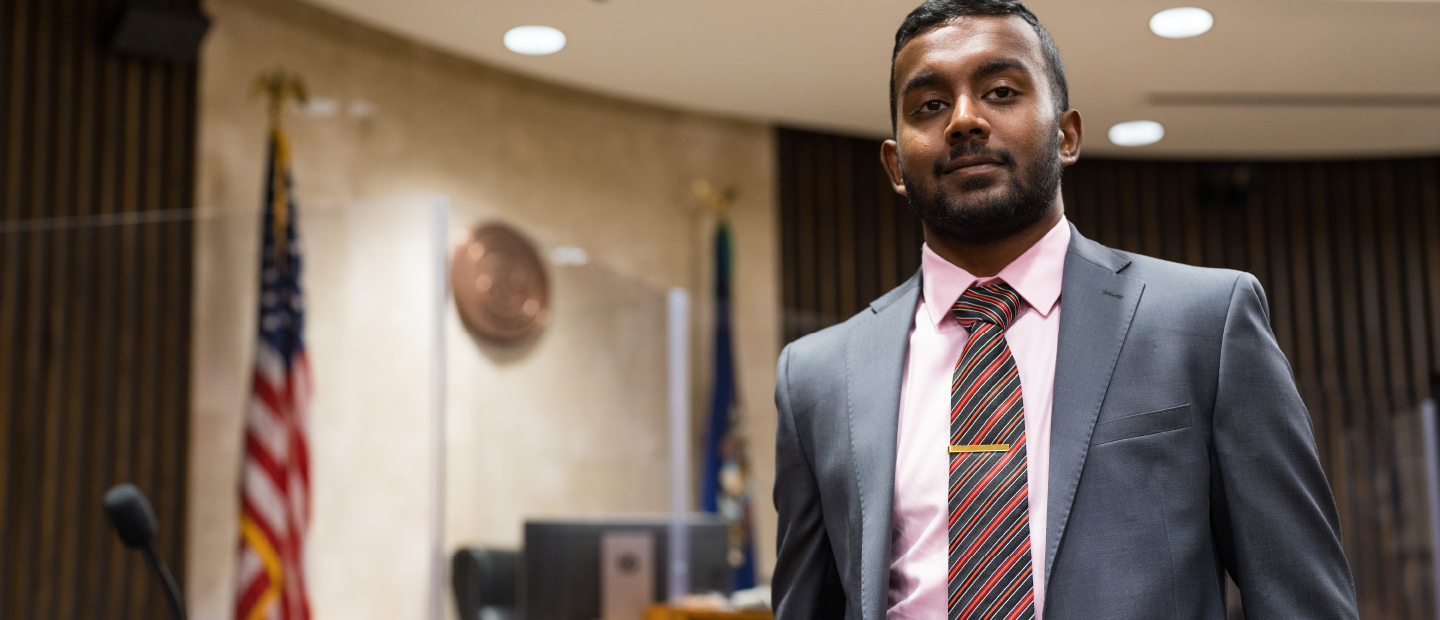 Man in suit standing in courtroom