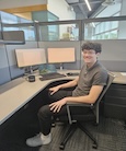 Alex Radcliffe seated at a desk