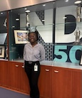Kymmie Chriswell standing in front of a display case