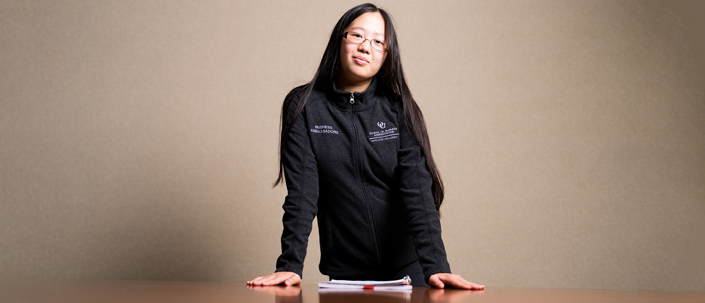 A student standing with their arms crossed