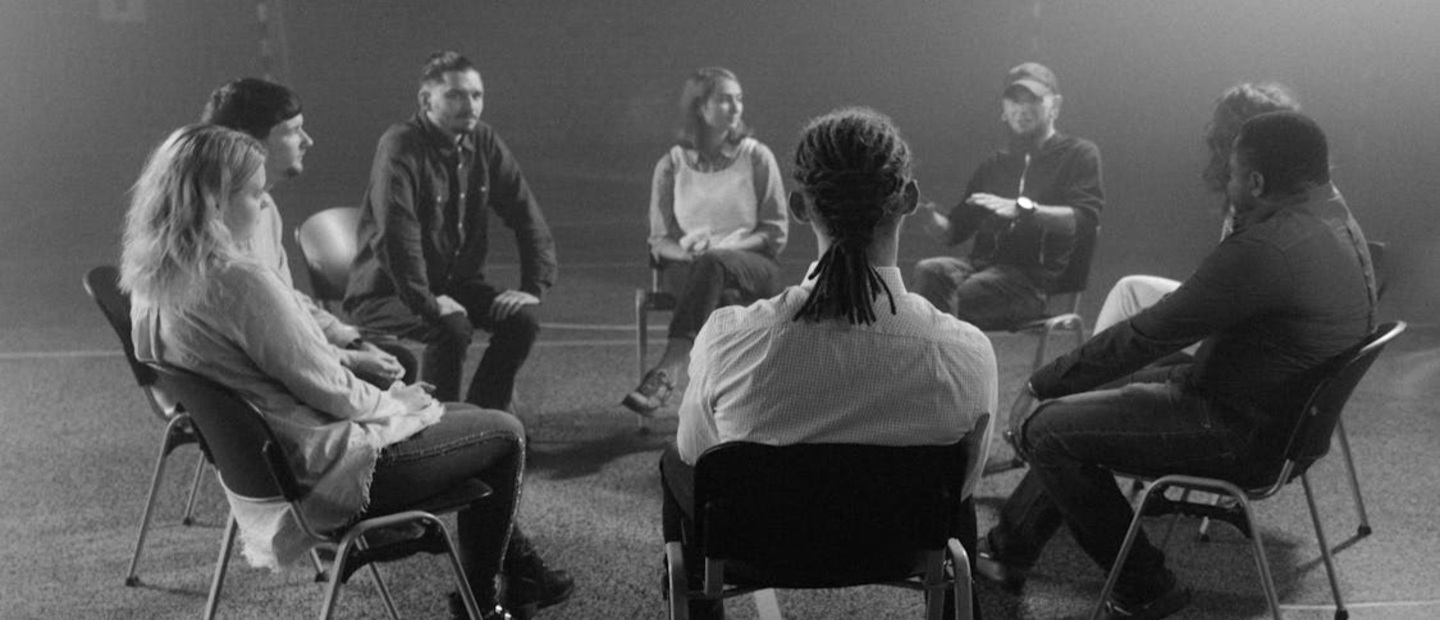 group of people sitting in a circle for a conversation