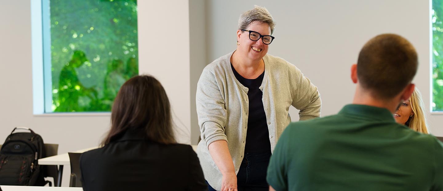 A professor standing in front of students in a classroom