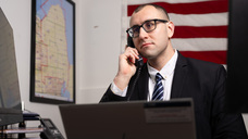 Patrick Stoddard on the phone, sitting in an office