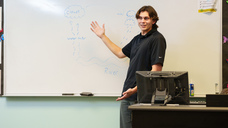 Trenton Brown presenting in front of a white board