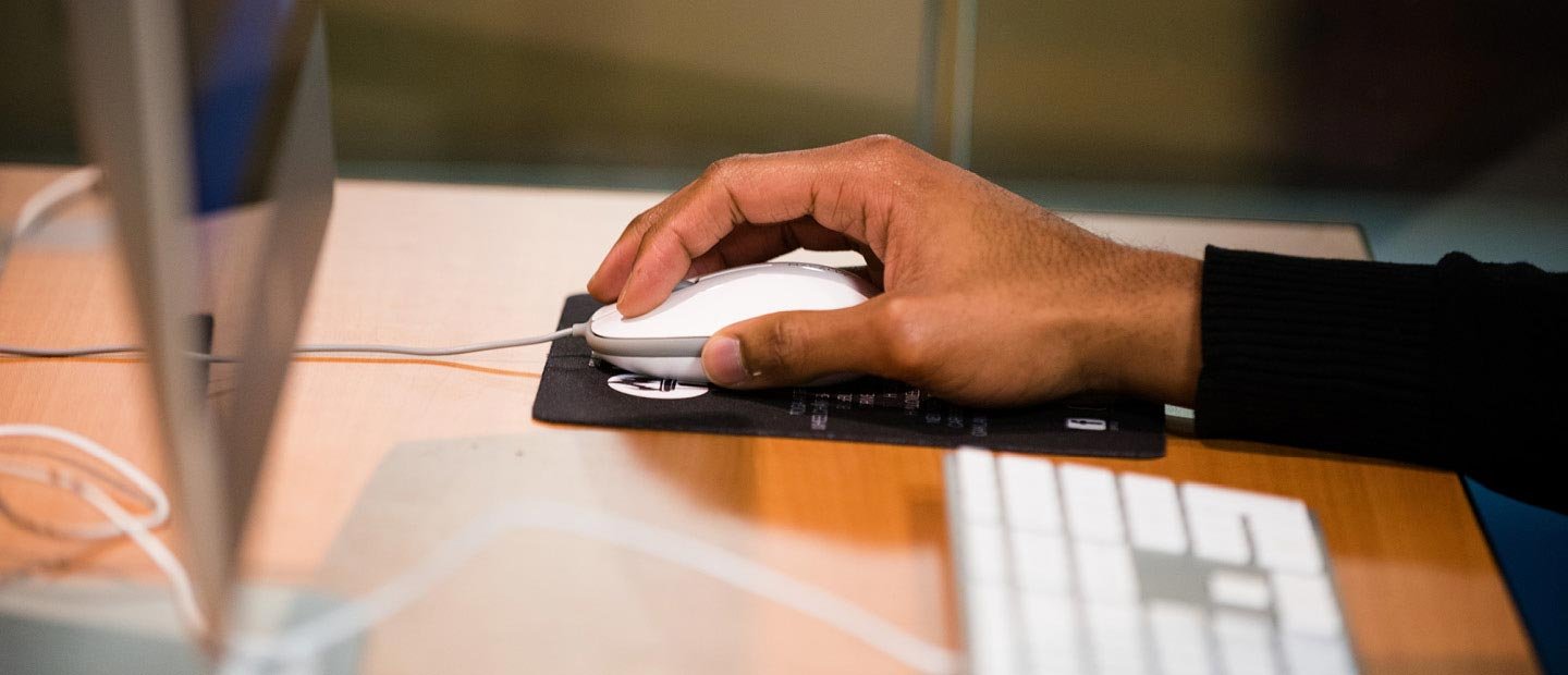 Closeup of a hand using a computer mouse