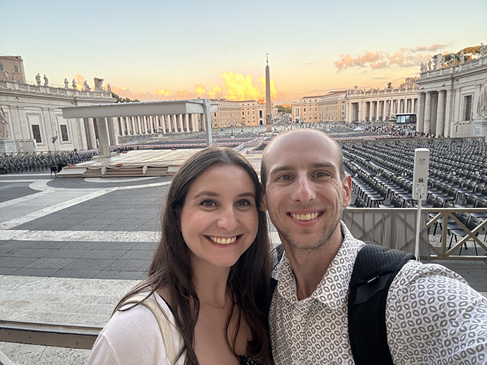 Michael Maguran (right) poses for a photo with a woman in front of a historic site.