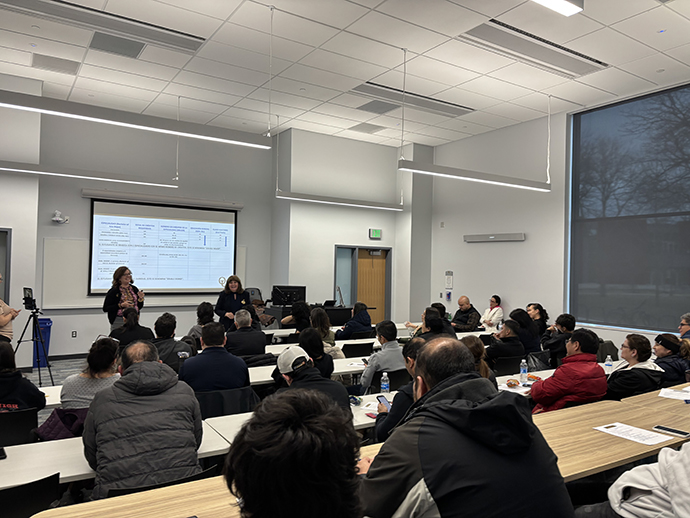 Oakland Associate Professor of Spanish Cecilia Saenz-Roby speaks to a group of students and parents.