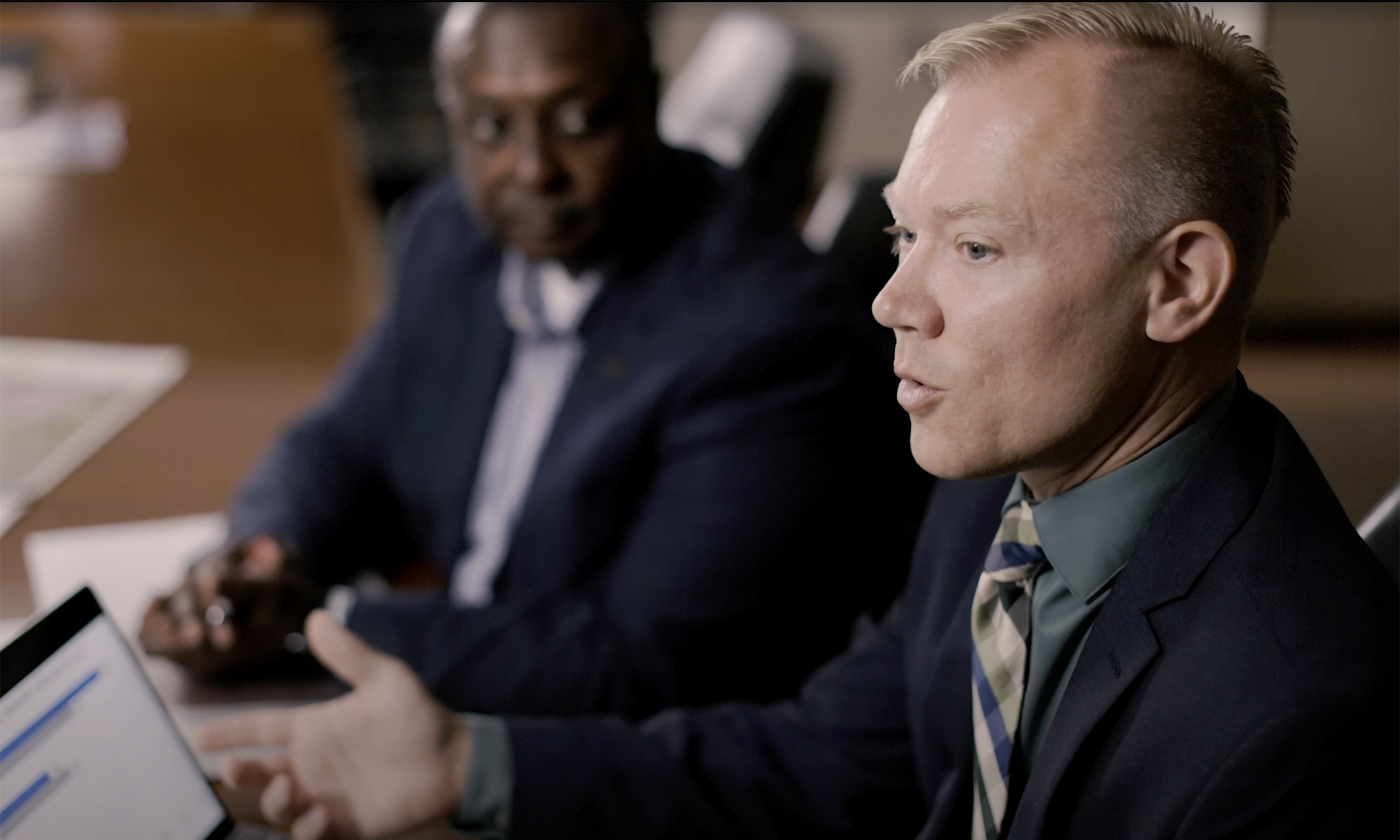 Oakland University Master of Public Administrator (MPA) Program Director and Professor Douglas Carr speaks at table full of people.