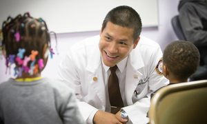 Dr. Yeow with two young patients