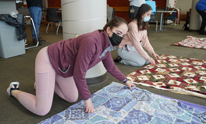 Students making tie blankets