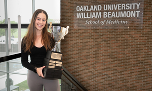 A student holding a trophy