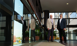 Two researchers in the halls of Corewell Health in Royal Oak