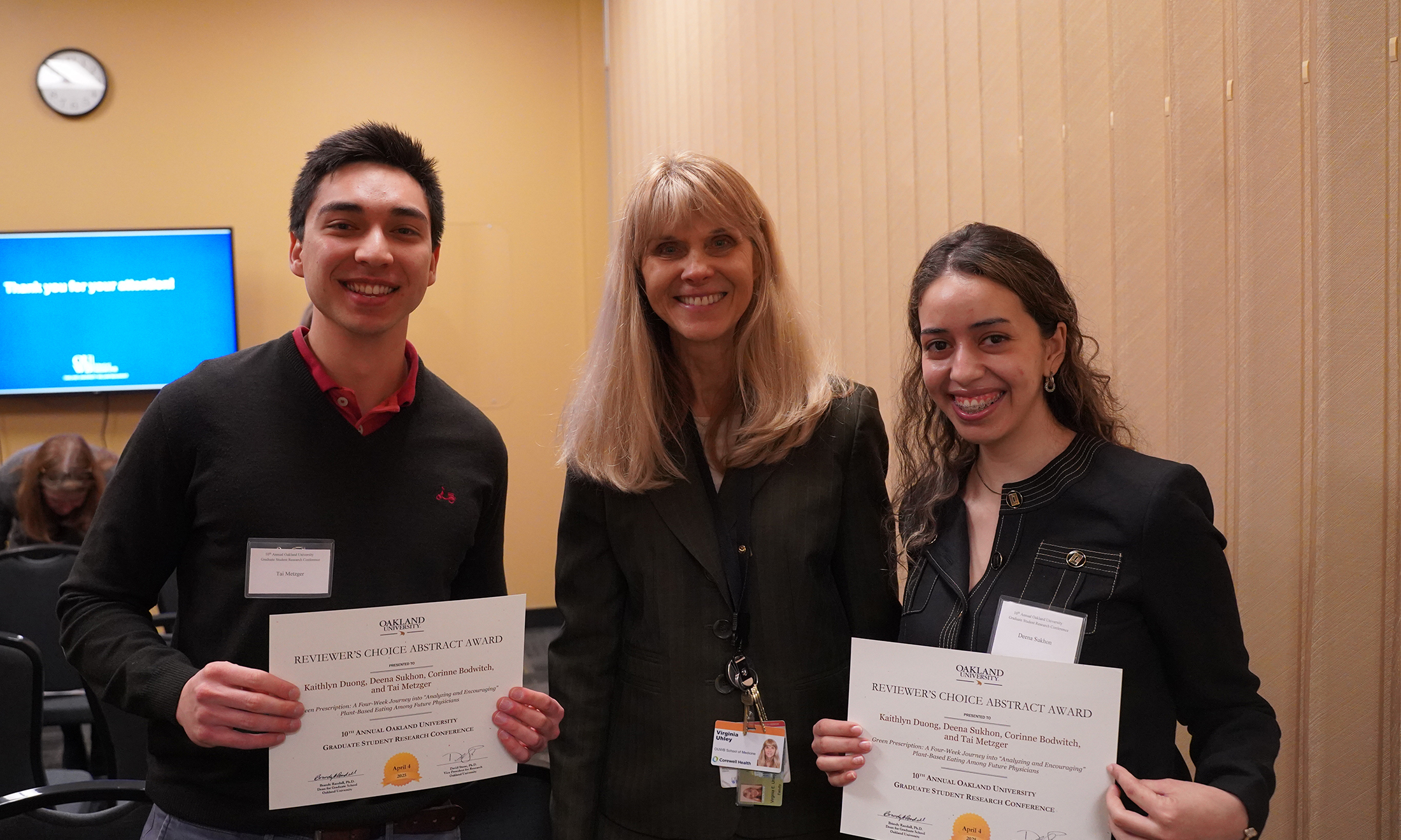An image of two students and a faculty member
