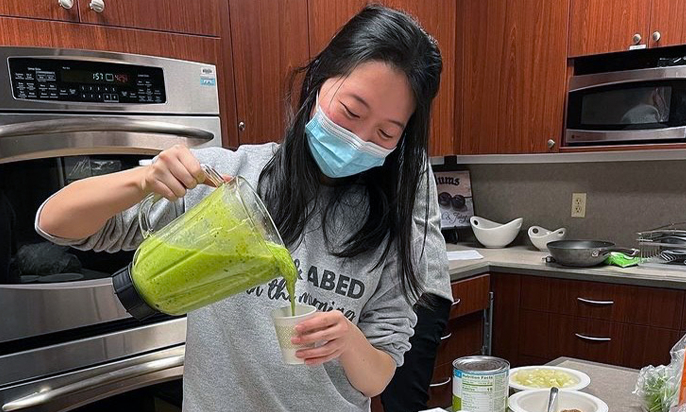 An image of a student pouring a drink