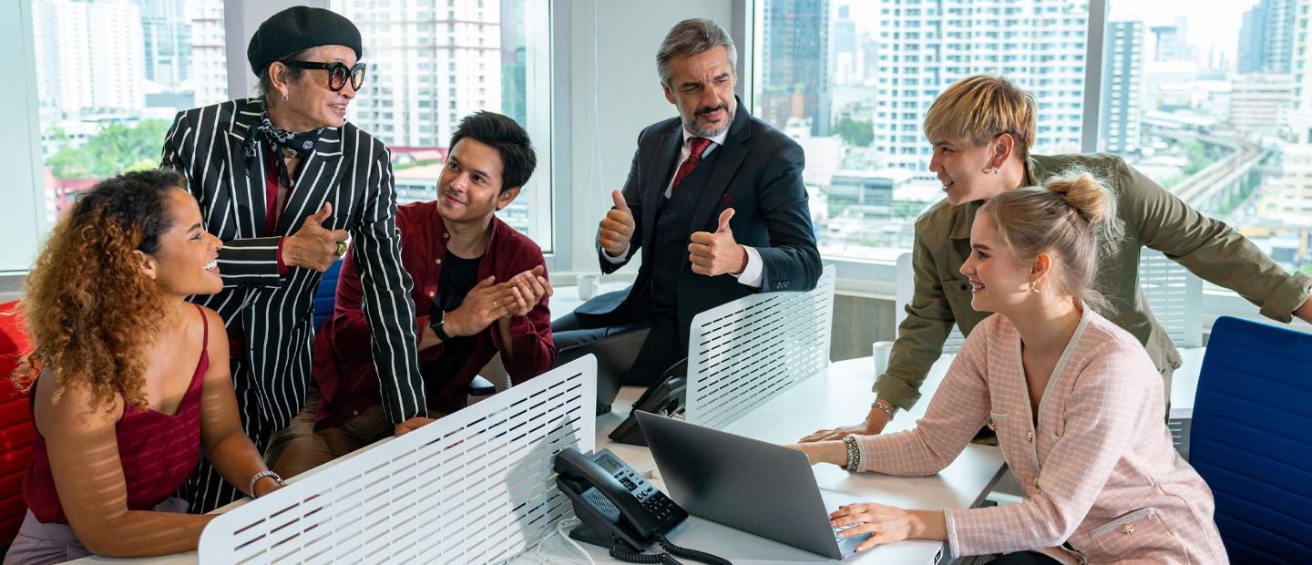 A group of people in an office enjoying talking to each other