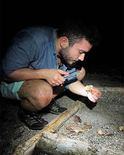 Victor D'Uva picking up Hermit Crabs