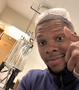 Calvin Goldsmith poses for a photo in the lab.