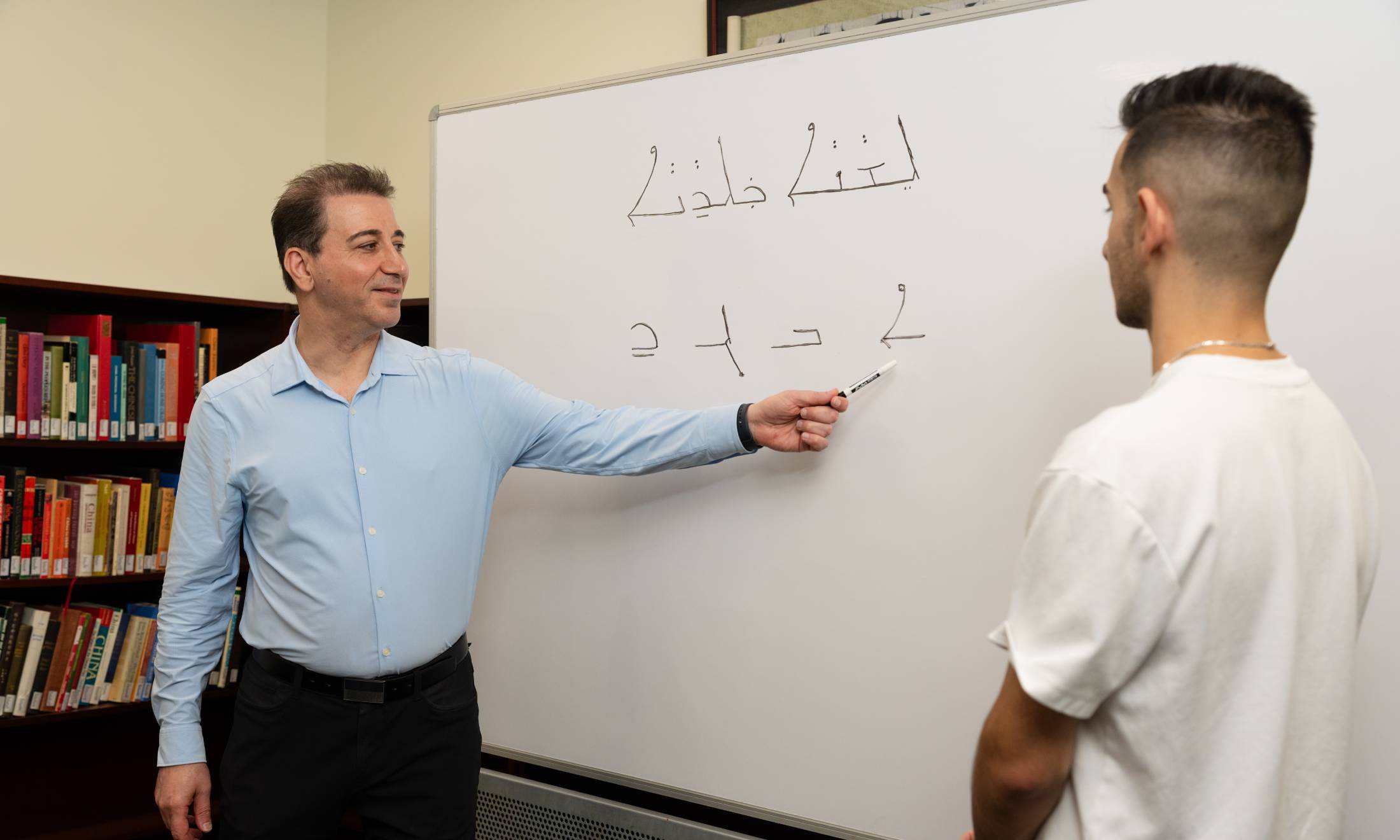 Teacher and student at whiteboard