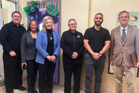 Provost Dr. Britt Rios-Ellis and School of Education and Human Services Dean Dr. Jon Margerum-Leys with PSA staff and Caniff staff.