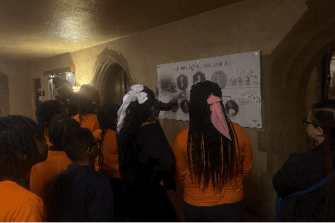 Weston Academy students looking at a poster at Meadow Brook Hall