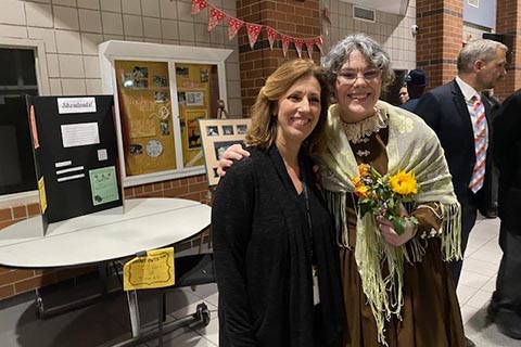 Two people smile at the camera