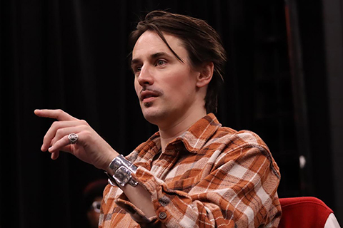 A man speaking on stage.