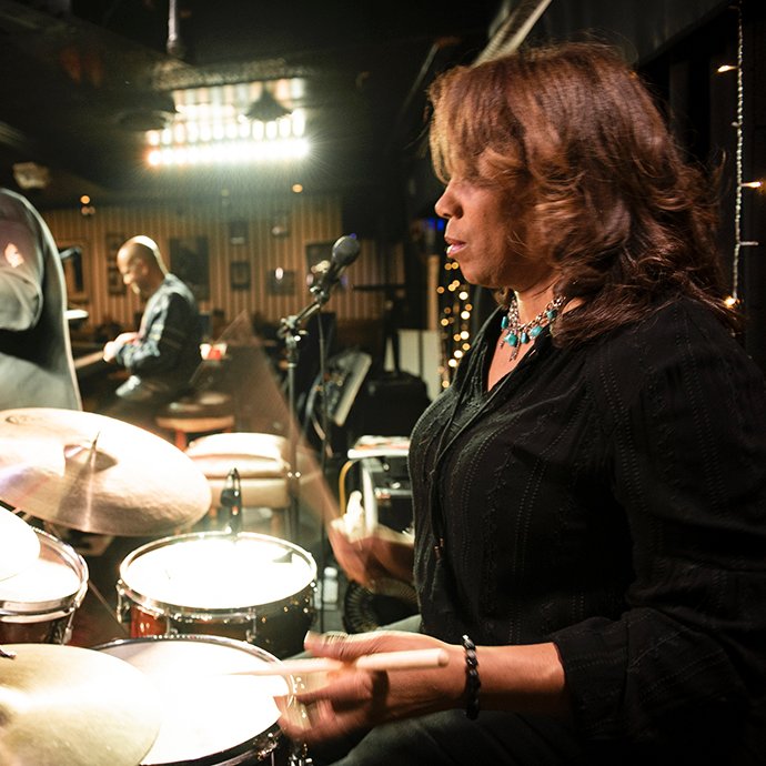 A woman playing drums