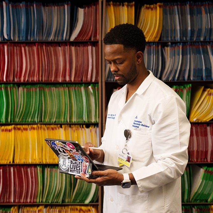 A man standing in front of a bookshelf