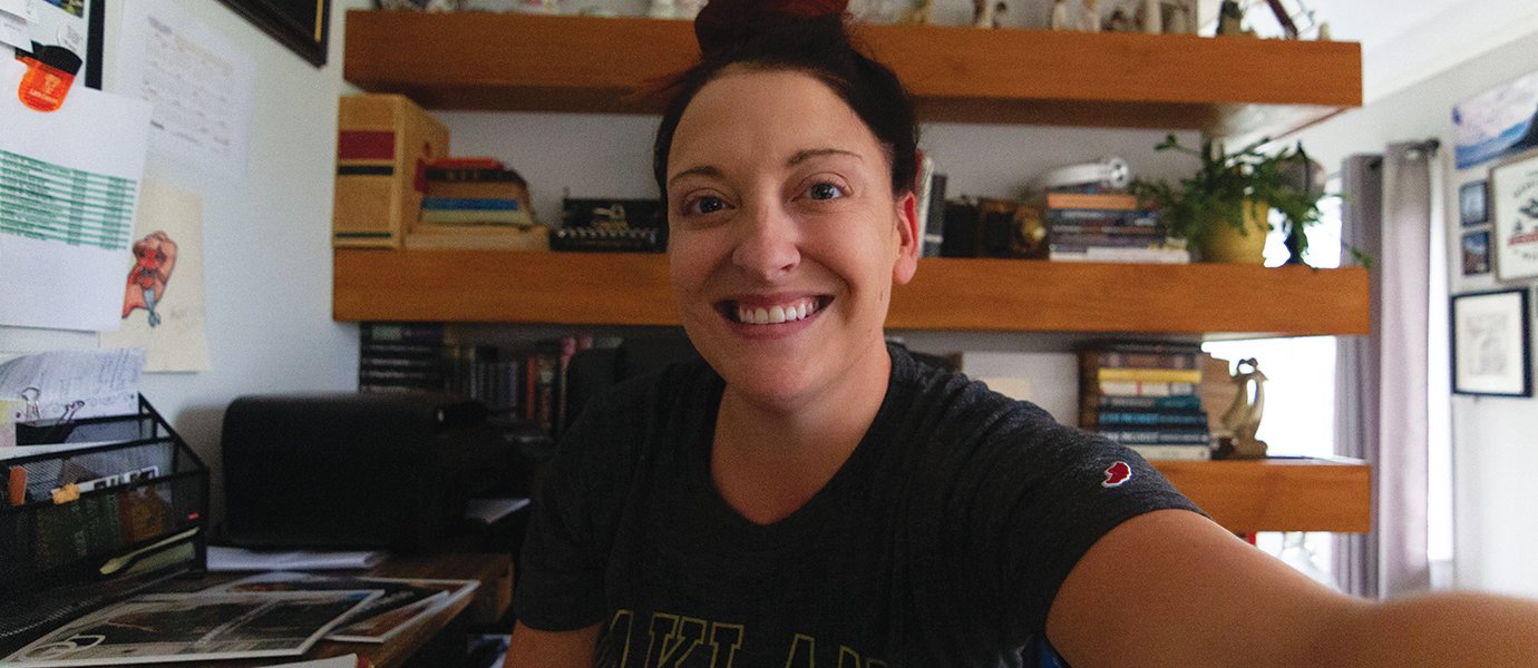 a selfie of a woman at her desk