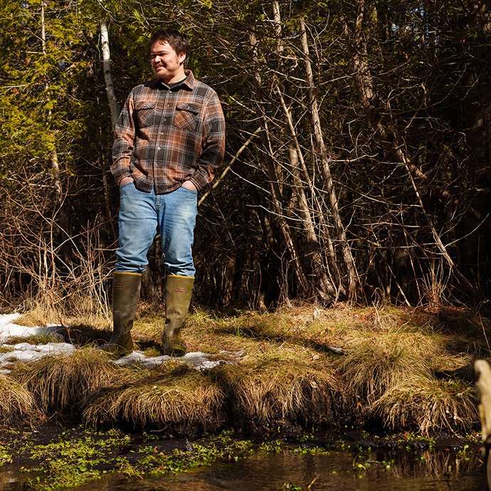 A person standing next to a river