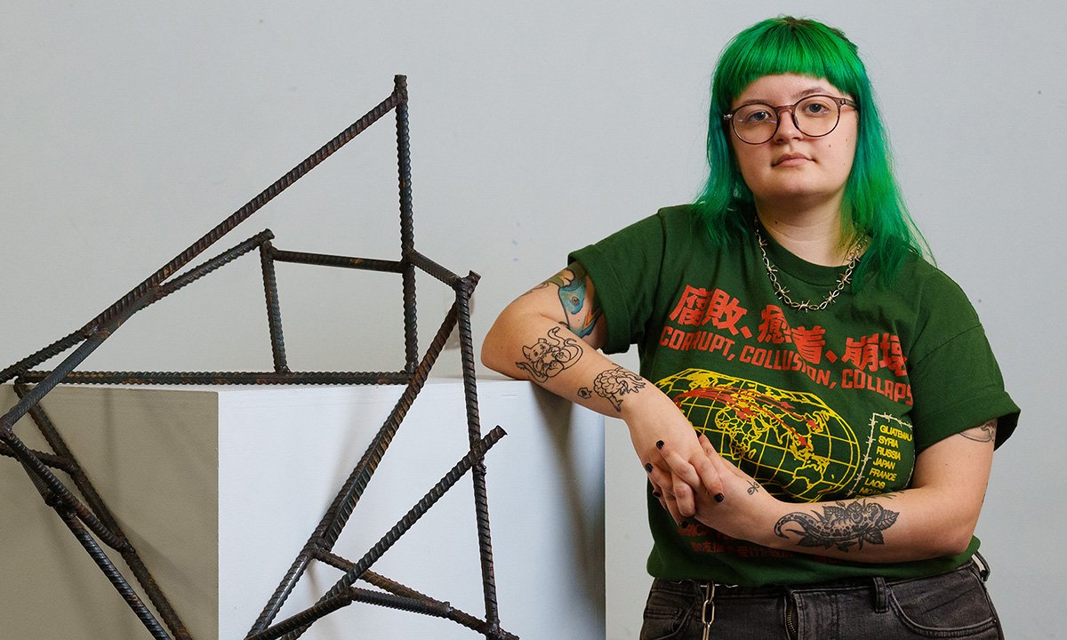 Person standing and leaning on a box