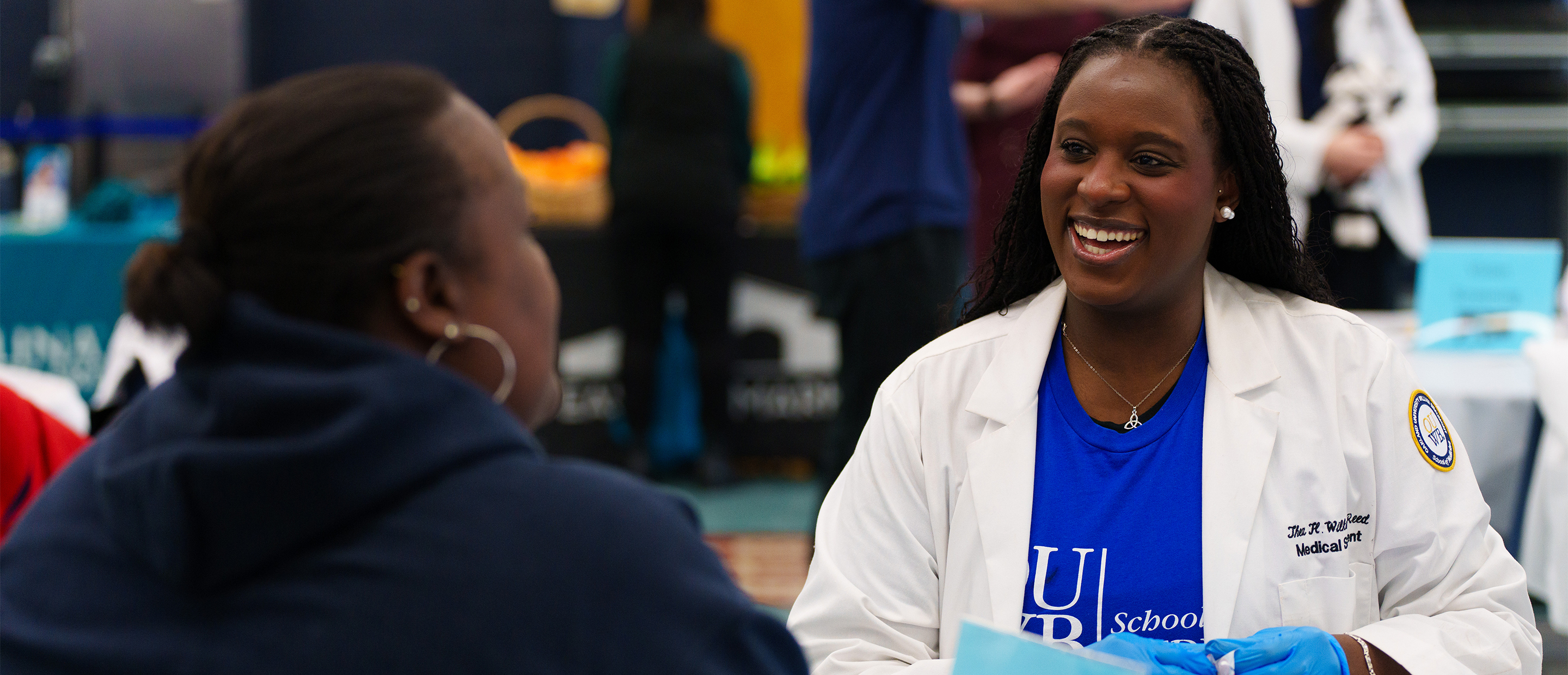 Admissions Requirements Banner An image of an OUWB student at a community event