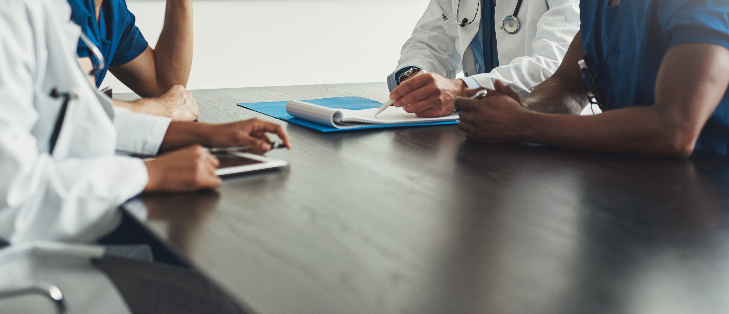 Embark - Health Systems Research Banner An image of a doctor and patient at a table