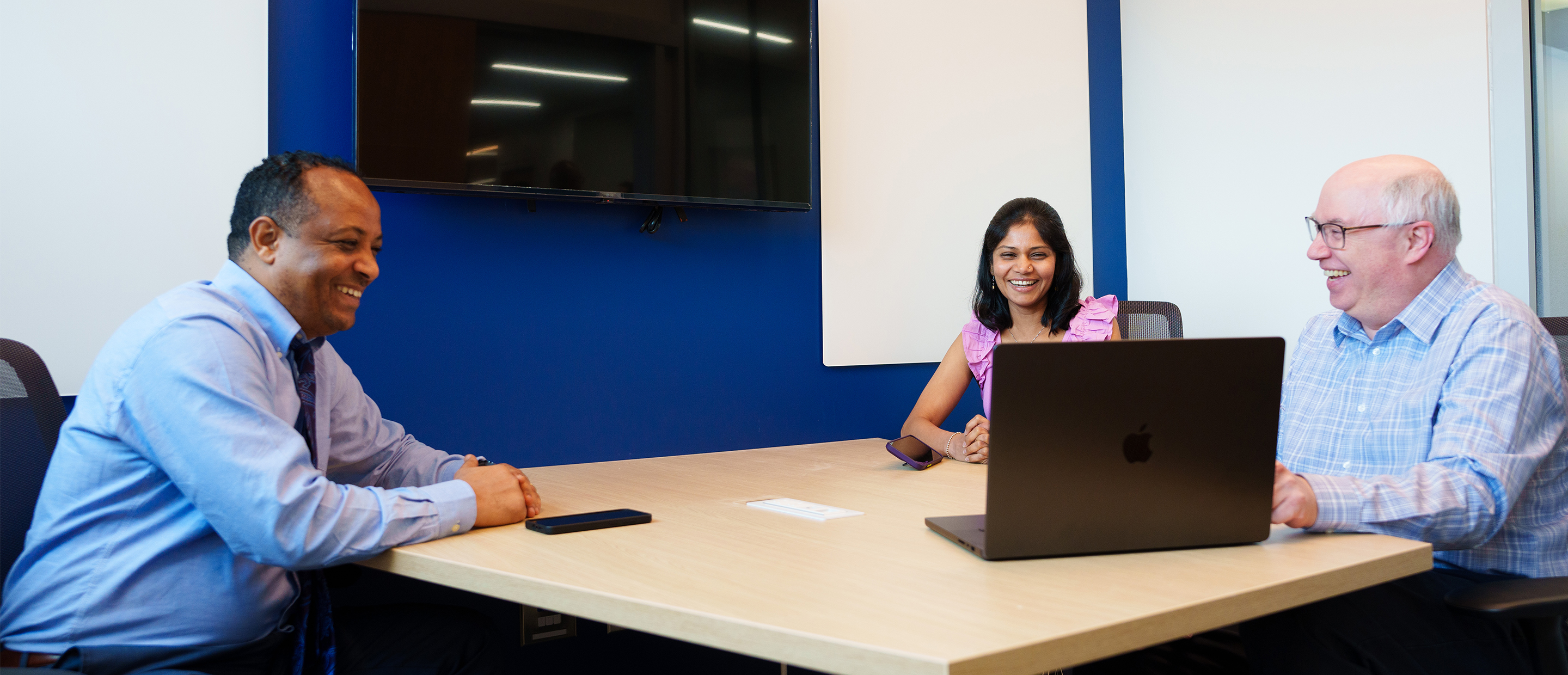 Faculty Affairs Banner An image of three faculty members sitting at a table