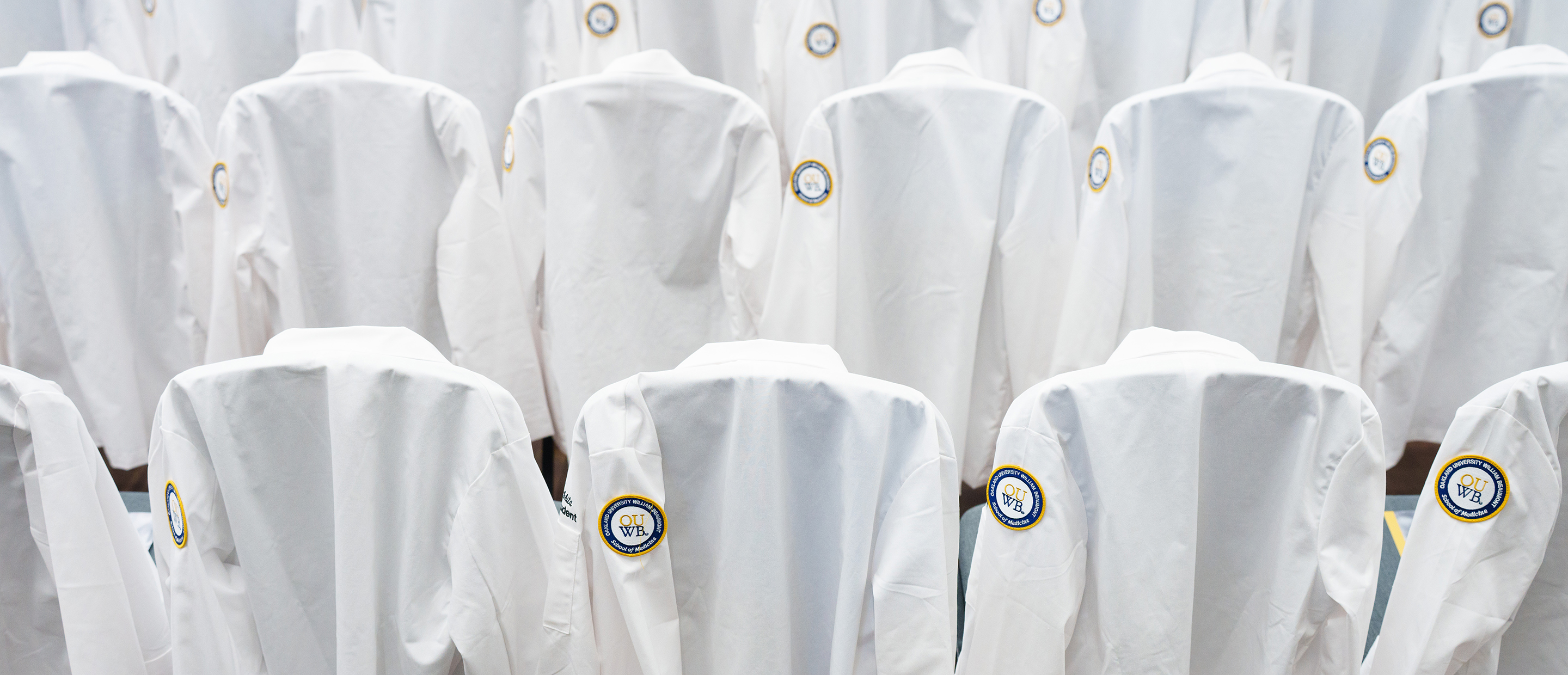 Records and Registration Banner An image of white coats with the OUWB patch