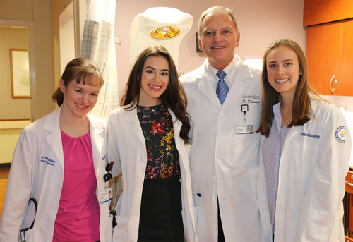 An image of a doctor and three medical students