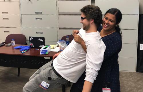 An image of two students practicing first aid
