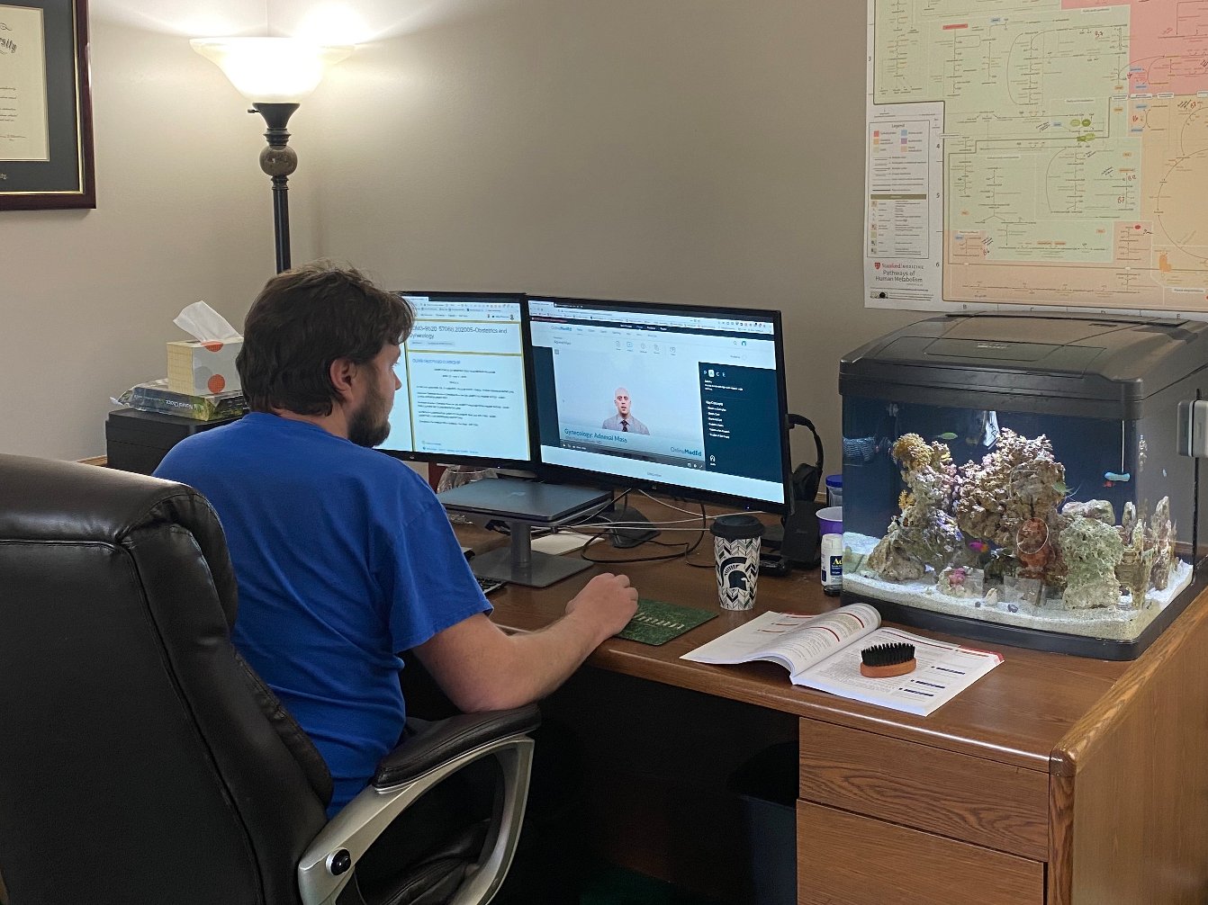 An image of someone working at a computer desk