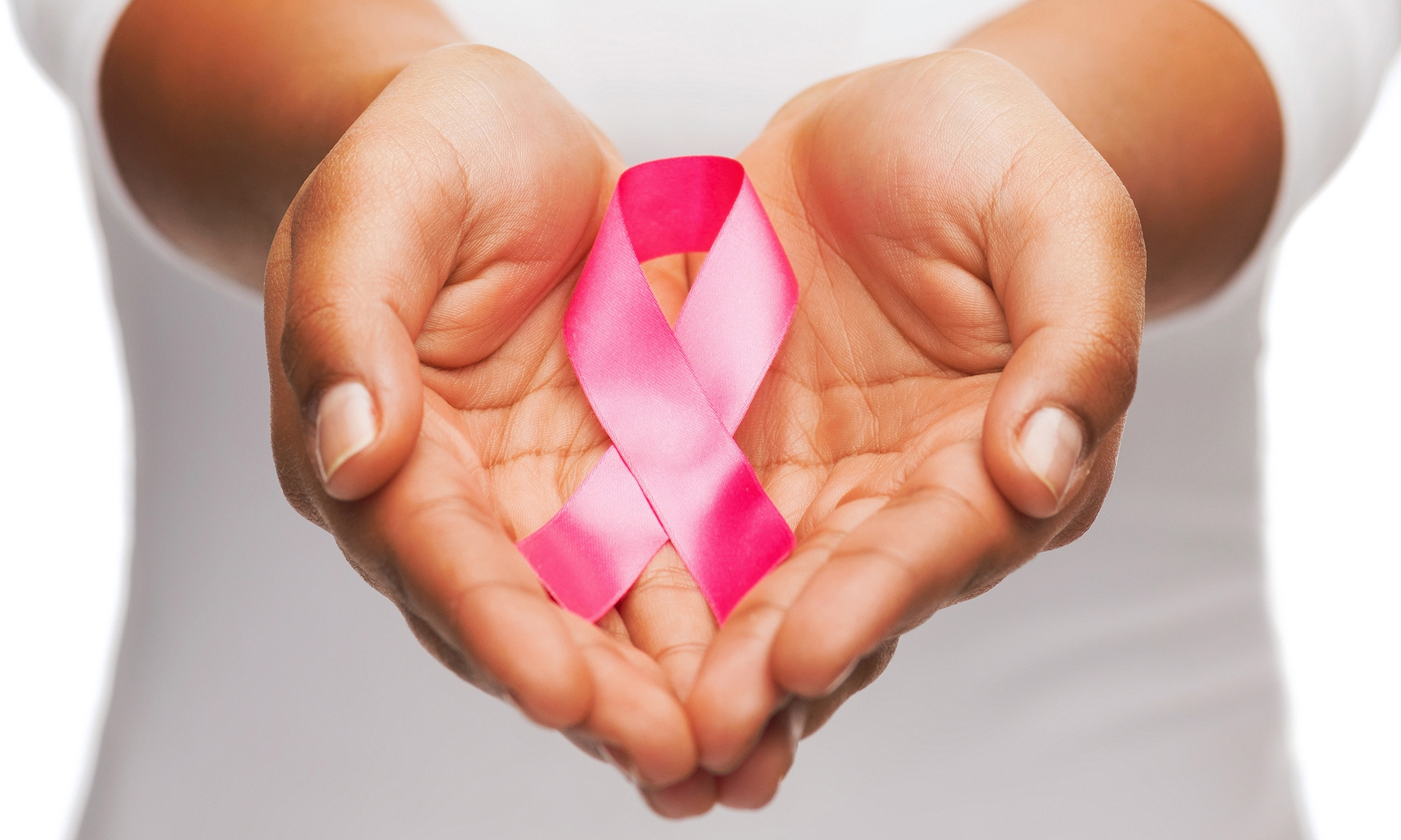 An image of hands holding a ribbon