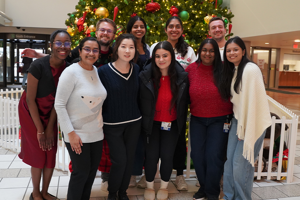 An image of the group in front of a Christmas tree