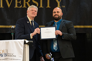 A student is presented a certificate