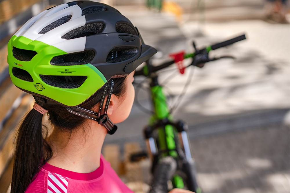 A young person wearing a bicycle helmet