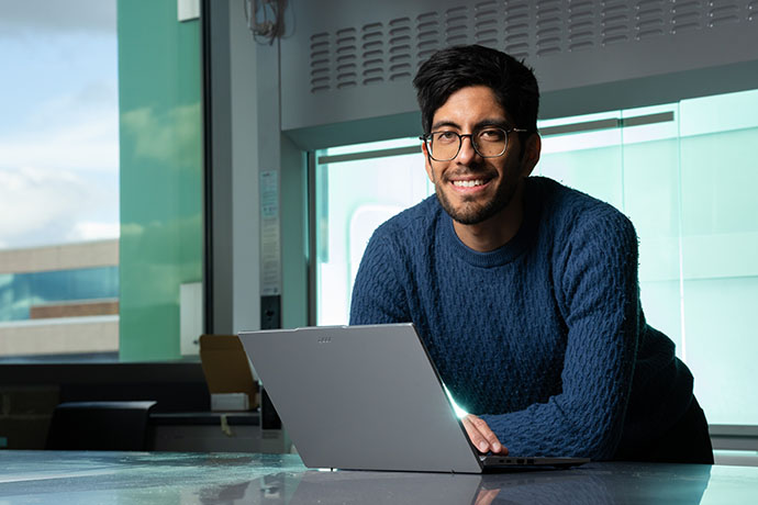 a professor looking up from a laptop