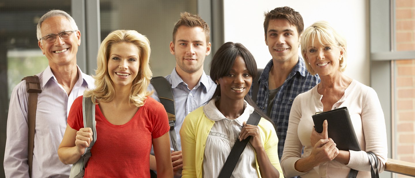 group of adults posing for a photo, smiling at the camera