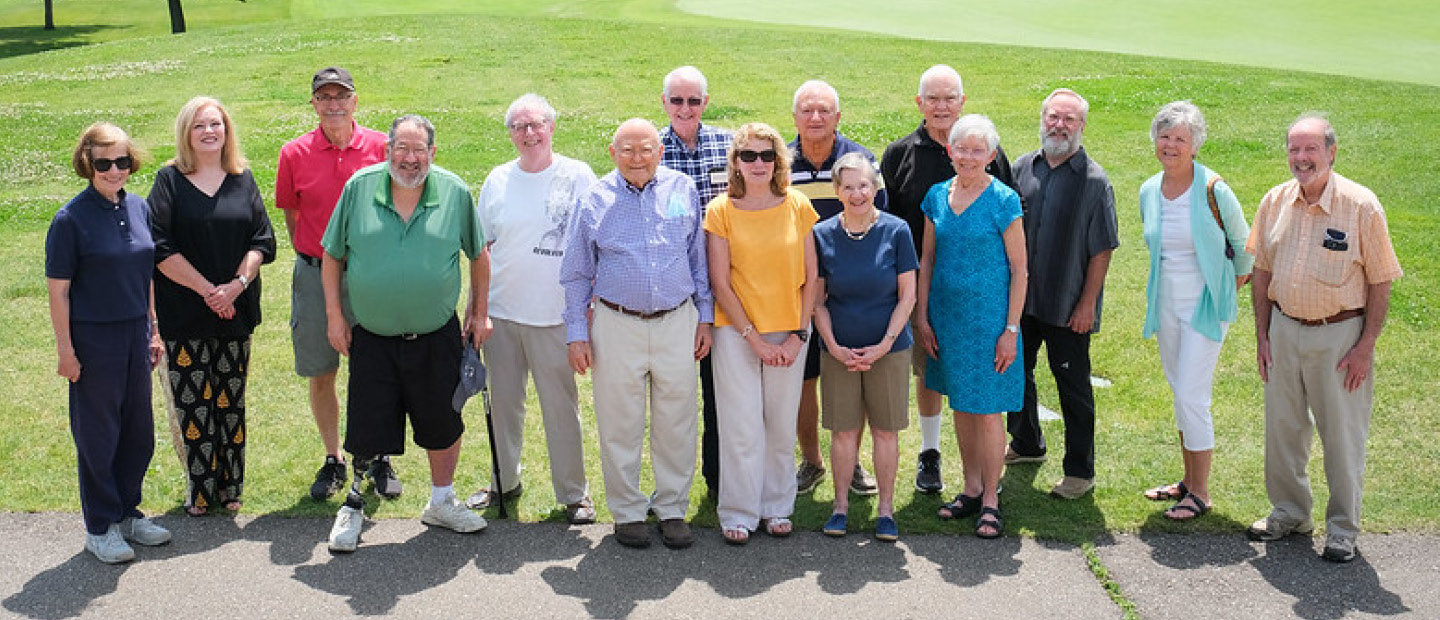 About Us Banner A group of Pioneer Club members posing for a photo outside