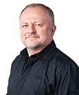 A headshot of Taras Oleksyk
